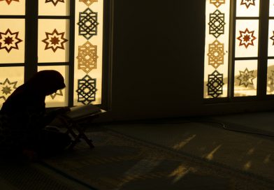 Muslim woman praying reciting Quran